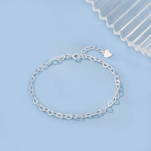Silver bracelet on a light blue background